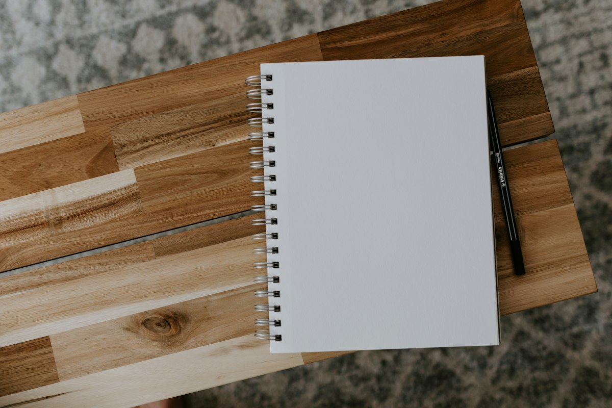 White spiral notebook on a wooden table